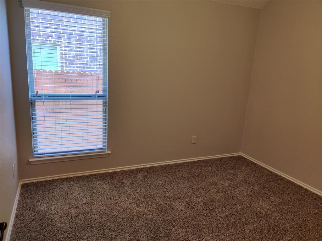 9901 Pronghorn Road McKinney, TX 75071 - Photo 24 of 27 an empty room with a window