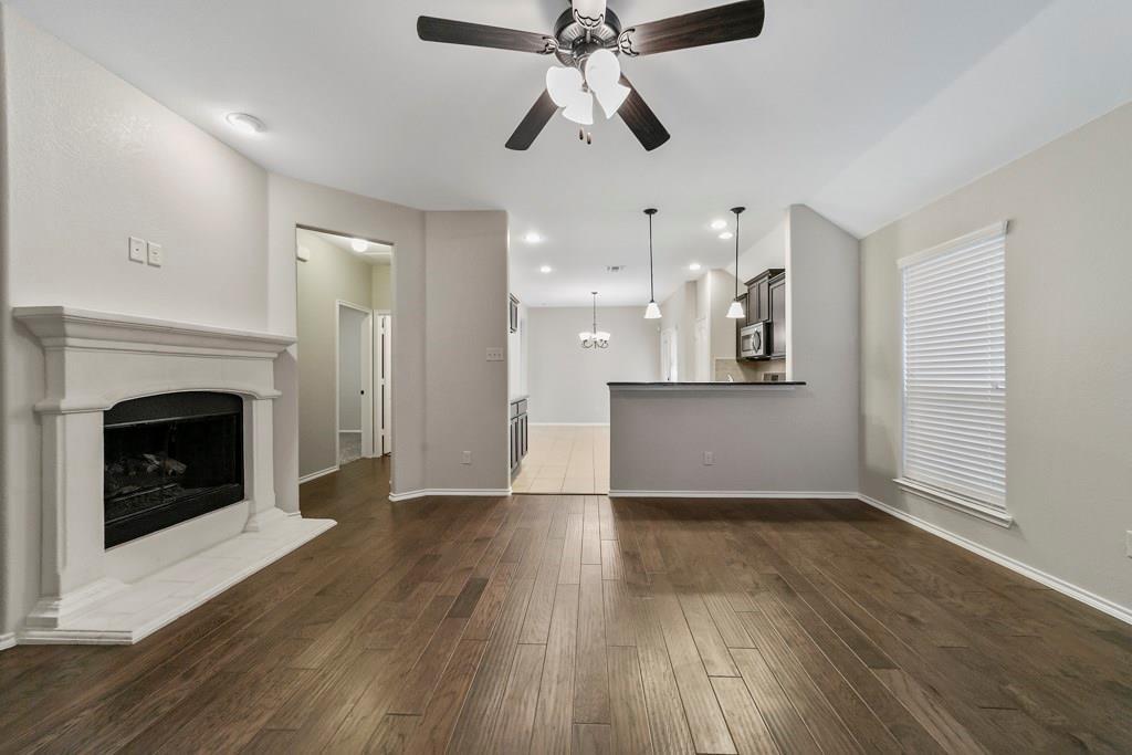 9901 Pronghorn Road McKinney, TX 75071 - Photo 3 of 27 a view of a kitchen wooden floor and a ceiling fan
