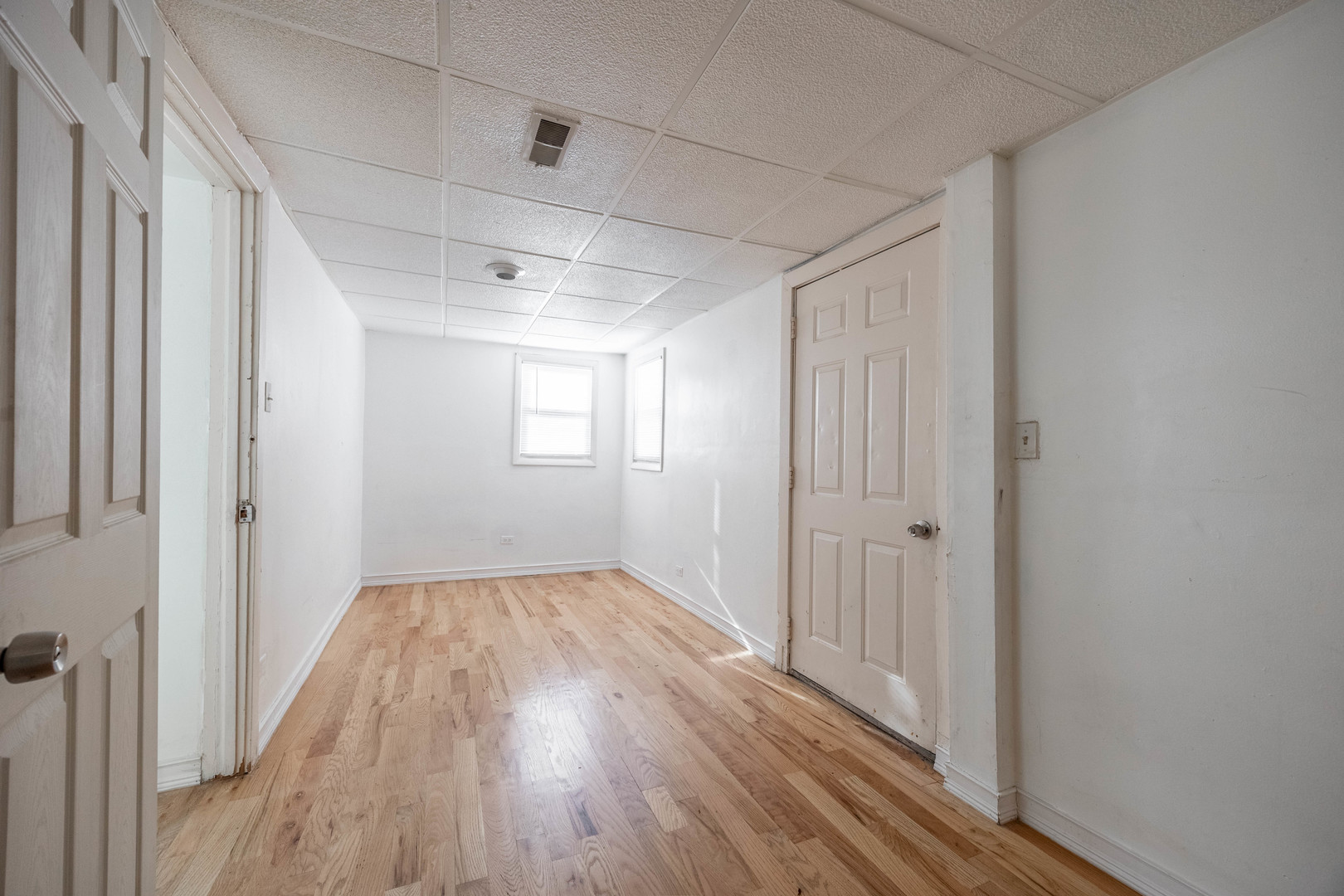 3248 West 25th Street, Unit 2 Chicago, IL 60623 - Photo 11 of 17 a view of an empty room with wooden floor and a window