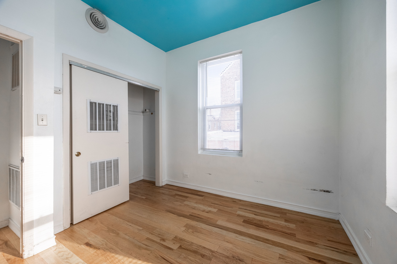 3248 West 25th Street, Unit 2 Chicago, IL 60623 - Photo 15 of 17 a view of an empty room with wooden floor and a window