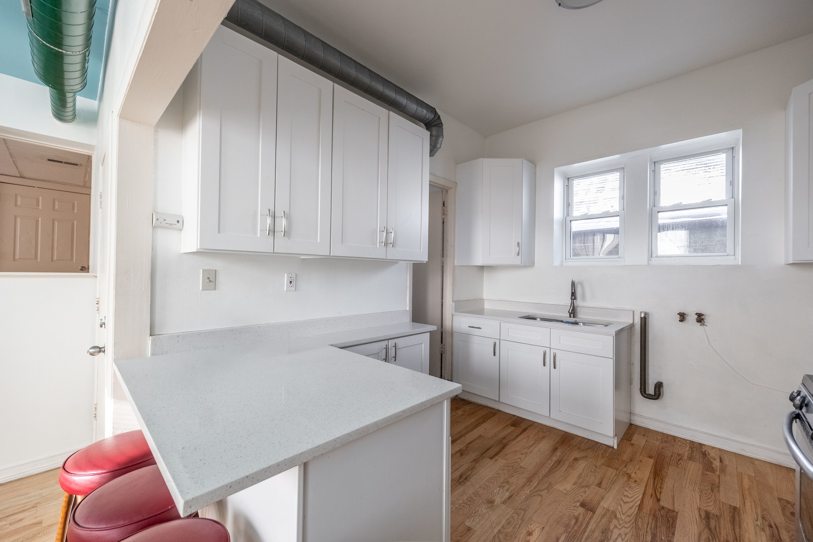 3248 West 25th Street, Unit 2 Chicago, IL 60623 - Photo 3 of 17 a kitchen with a sink cabinets and wooden floor