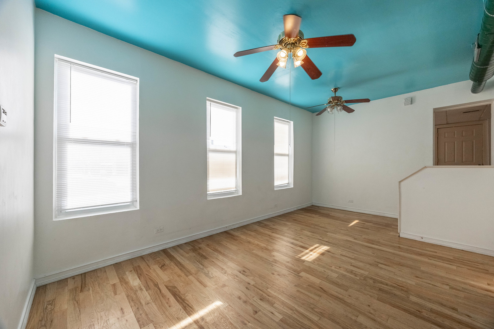 3248 West 25th Street, Unit 2 Chicago, IL 60623 - Photo 7 of 17 a view of empty room with wooden floor and fan