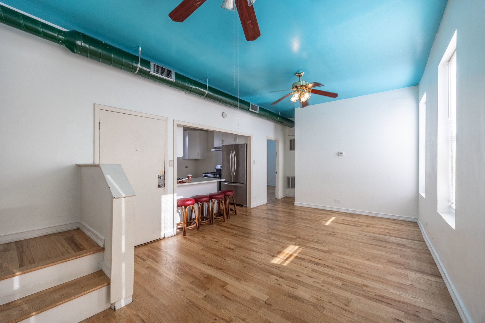 3248 West 25th Street, Unit 2 Chicago, IL 60623 - Photo 8 of 17 wooden floor in an empty room with a window