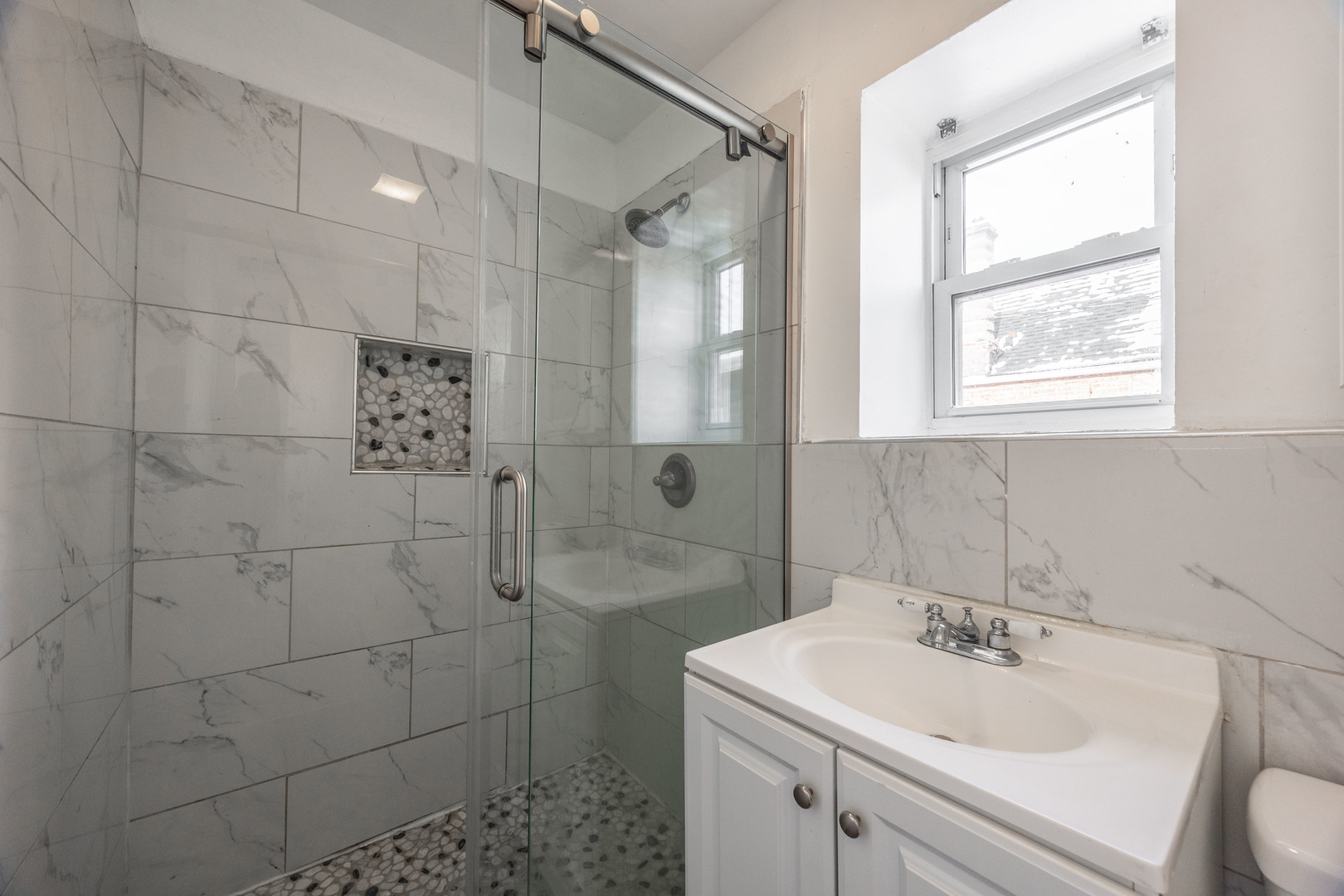 3248 West 25th Street, Unit 2 Chicago, IL 60623 - Photo 10 of 17 a bathroom with a sink a toilet and shower