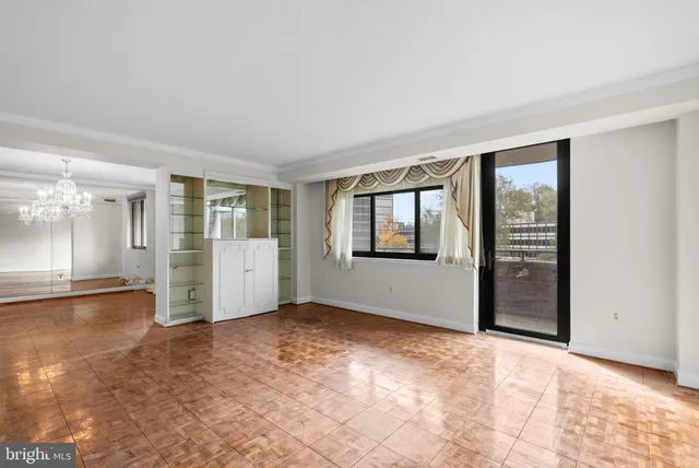 an empty room with windows and entrance