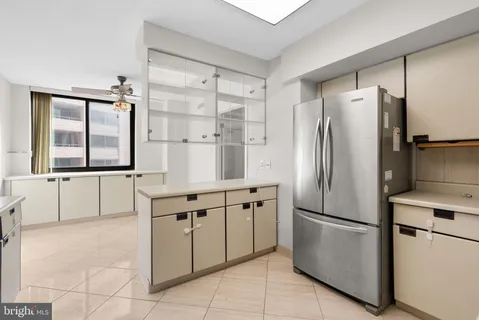 a kitchen with stainless steel appliances a refrigerator sink and cabinets