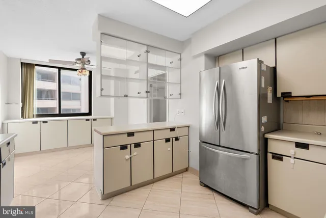 a kitchen with stainless steel appliances a refrigerator sink and cabinets