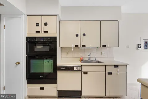 a kitchen with stainless steel appliances a sink stove and cabinets