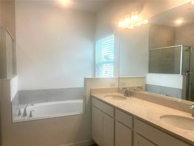 a bathroom with a bathtub and a shower