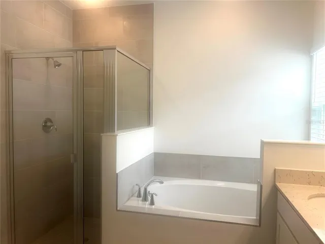 a white toilet sitting next to a shower