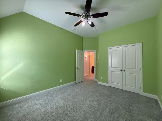 a view of a room with a sink and a ceiling fan