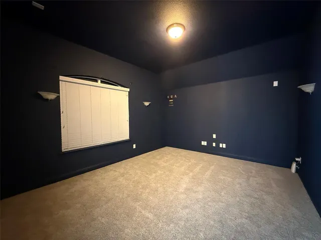 a view of an empty room and a window