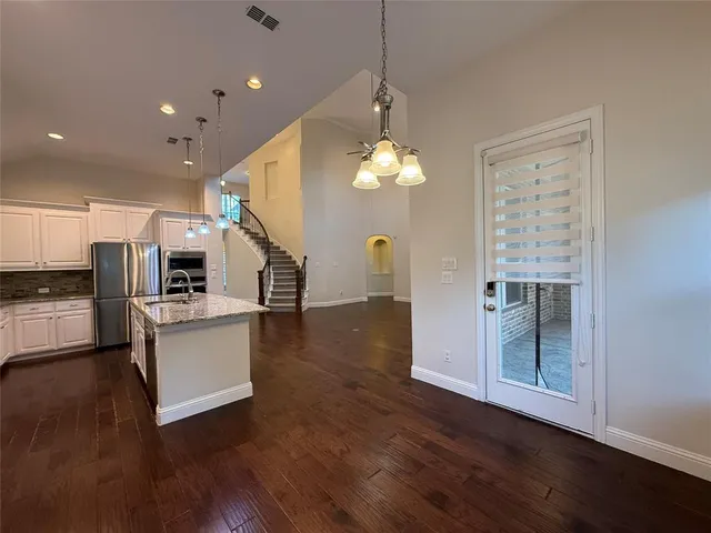 a view of kitchen with furniture and wooden floor