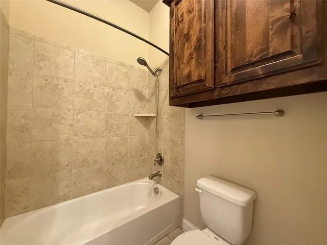 a bathroom with a double vanity sink toilet mirror and bathtub