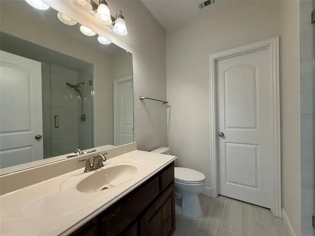 a spacious bathroom with a sink and a mirror