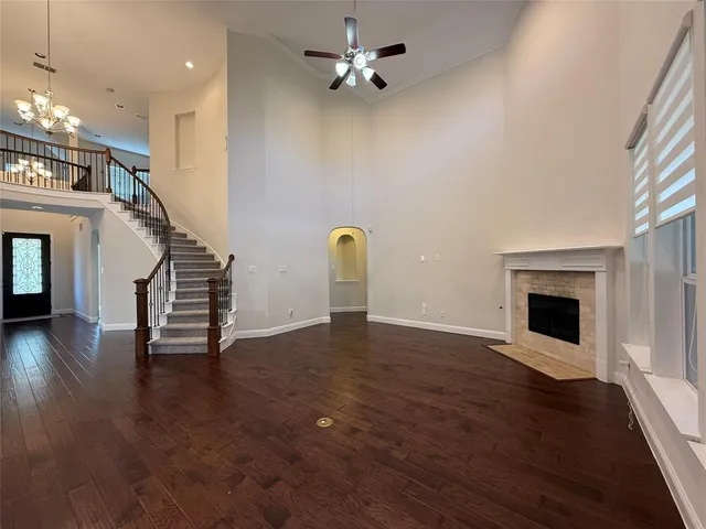 a view of a livingroom with wooden floor and a ceiling fan
