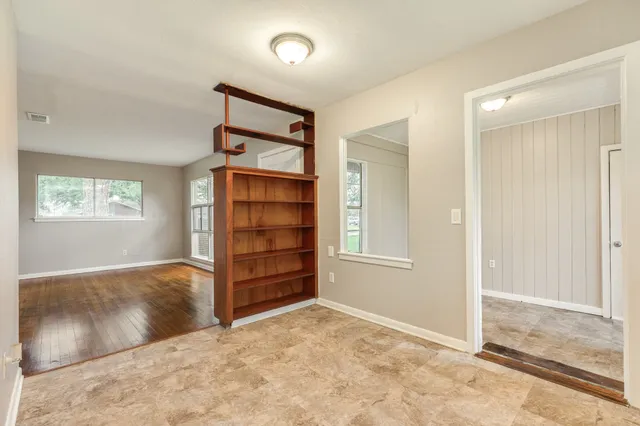 an empty room with windows and closet