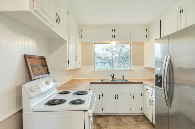a kitchen with a white stove top oven and refrigerator