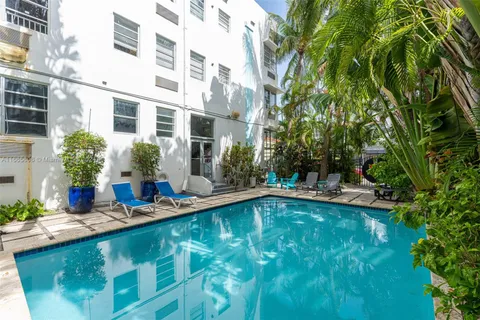 a view of a house with swimming pool and sitting area