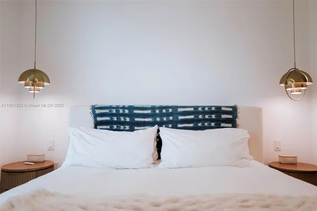a large white bed in a white room
