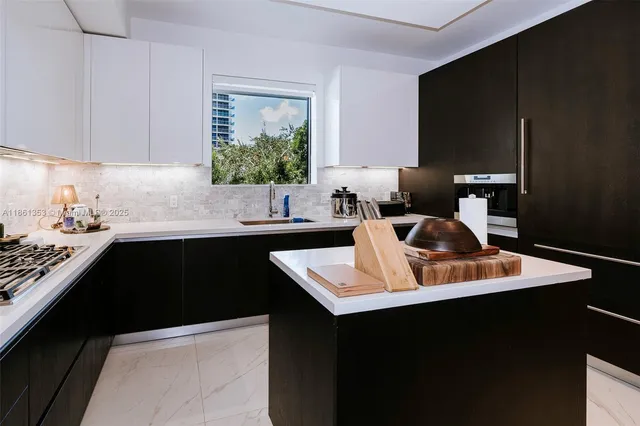 a kitchen with a sink dishwasher and cabinets with wooden floor