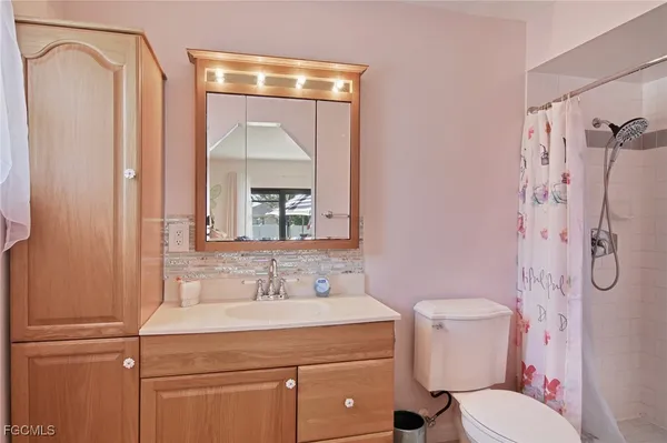 a bathroom with a sink toilet and shower
