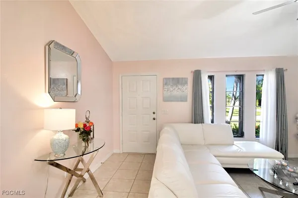 a living room with furniture and a mirror