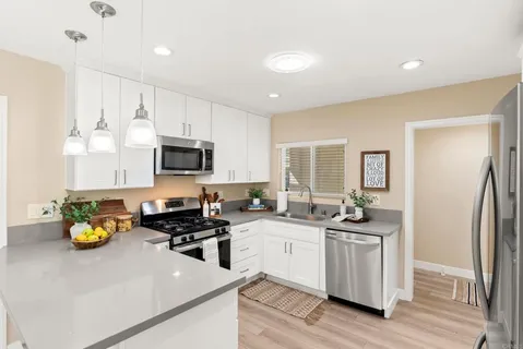 a kitchen with a sink appliances and cabinets