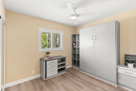 a view of a kitchen with wooden floor and electronic appliances