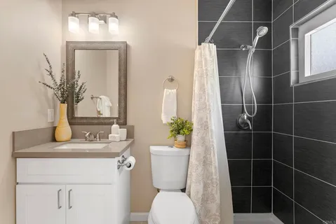 a bathroom with a sink a toilet and mirror