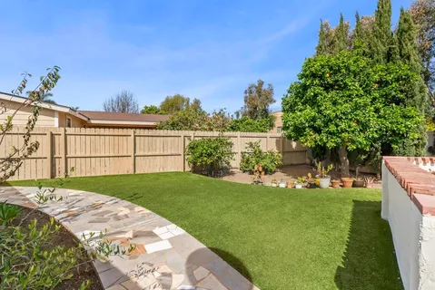 a view of a backyard with sitting area