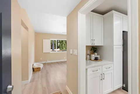 a kitchen with white cabinets and a sink