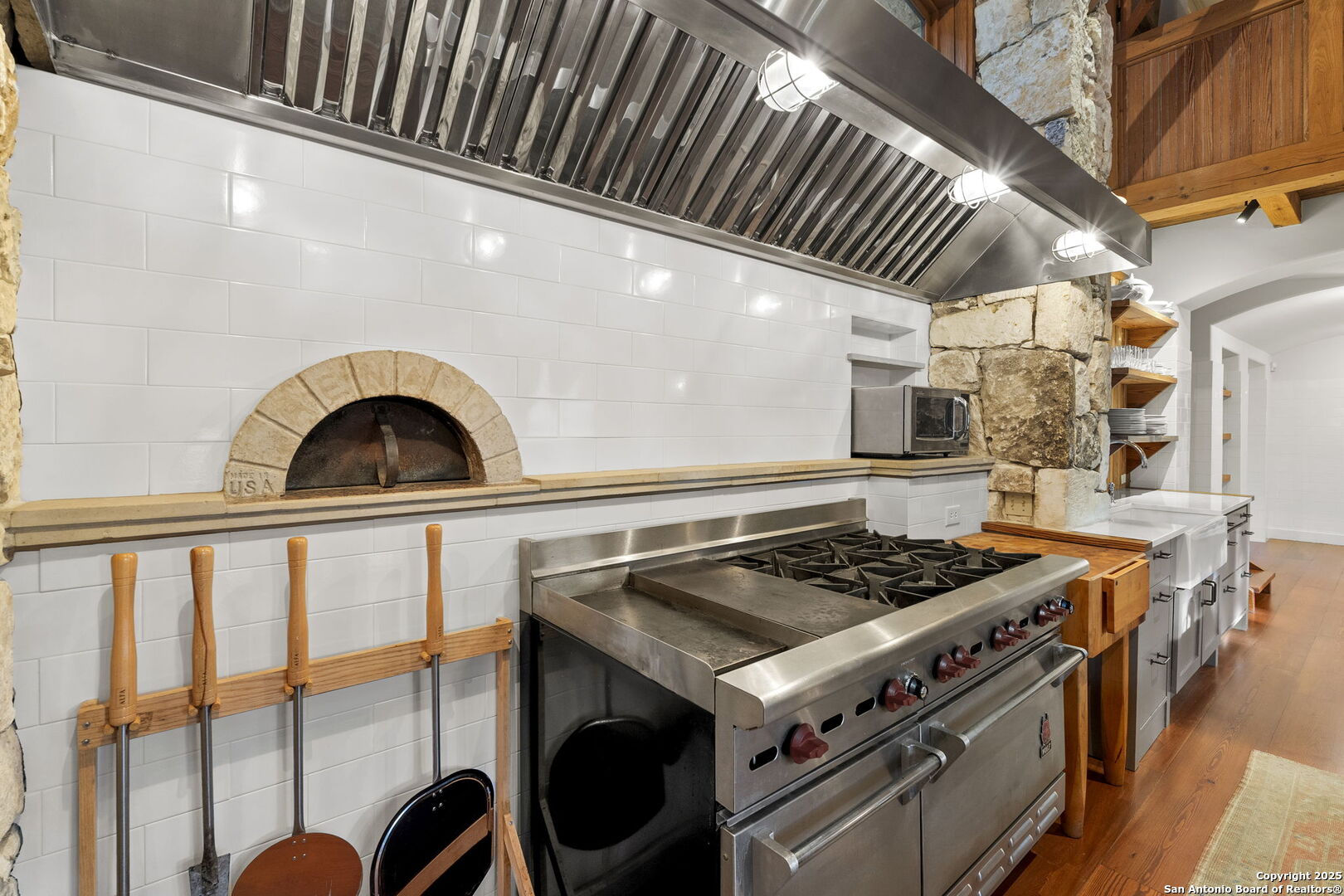 317 Limestone Crk Road Hill Country Village, TX 78232 - Photo 11 of 51 a stove top oven sitting inside of a kitchen