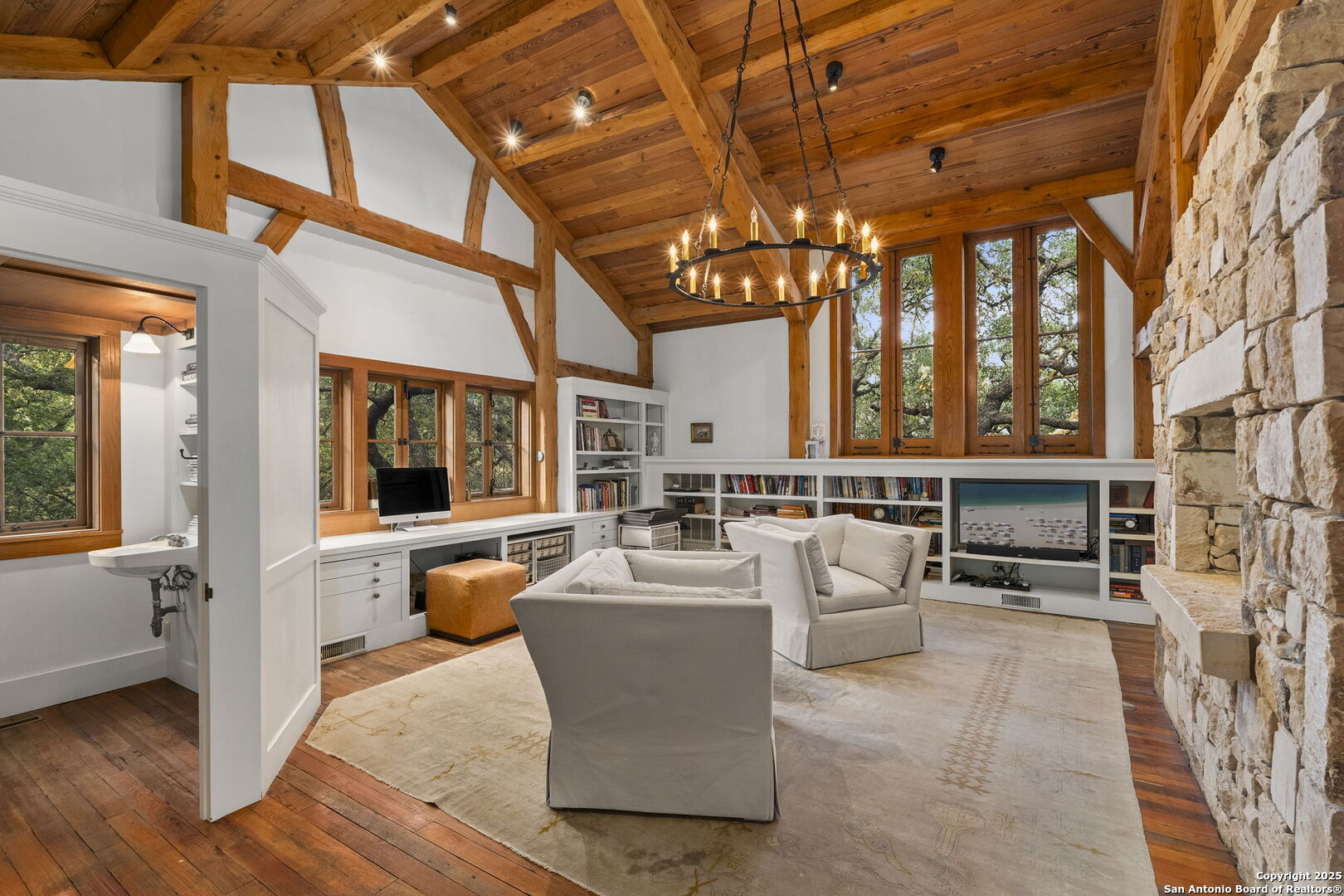 317 Limestone Crk Road Hill Country Village, TX 78232 - Photo 19 of 51 a living room with furniture and a chandelier