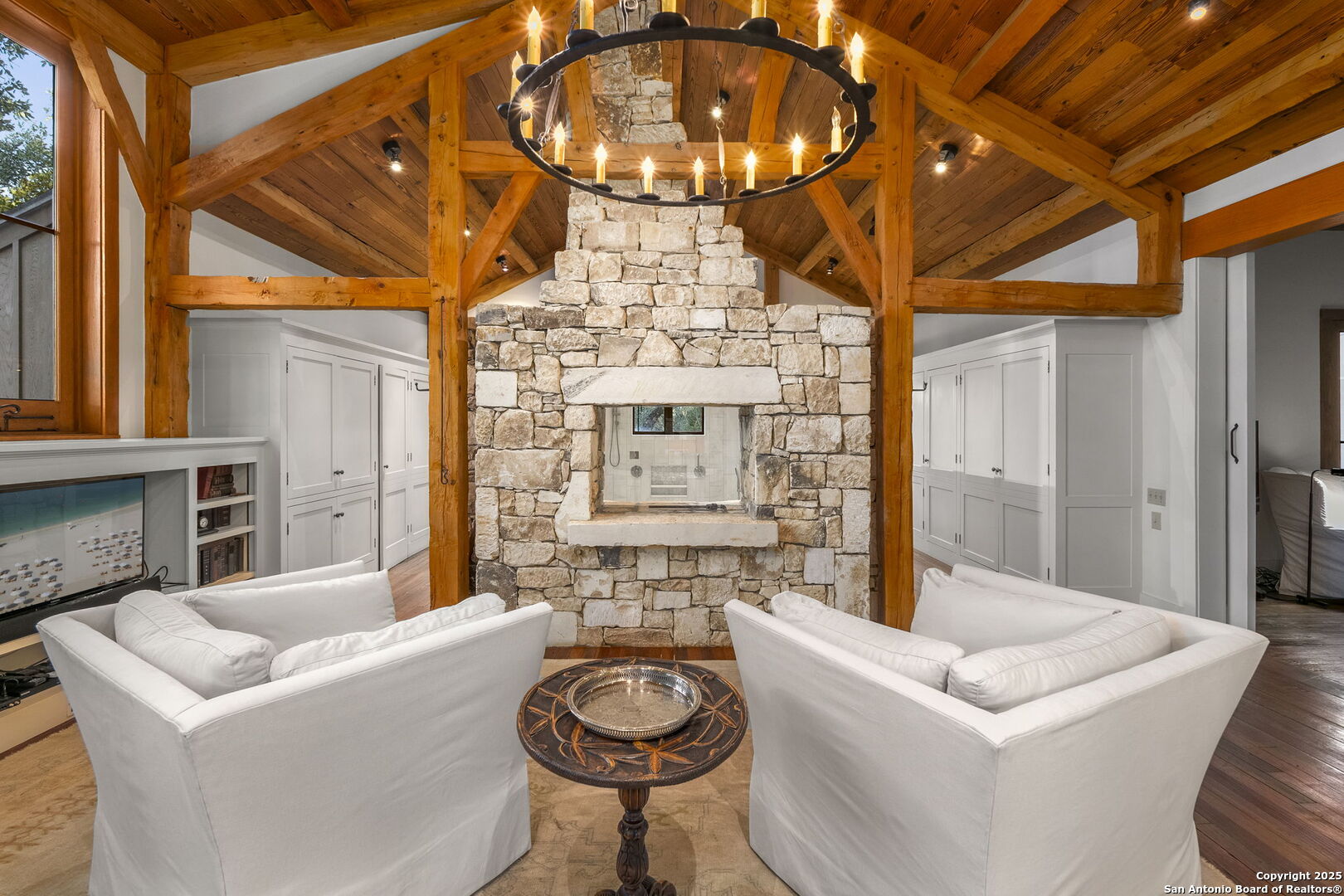317 Limestone Crk Road Hill Country Village, TX 78232 - Photo 20 of 51 a living room with furniture a fireplace and a chandelier