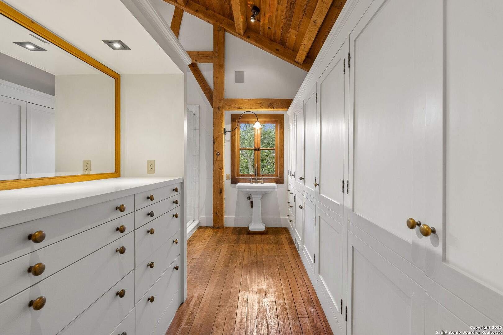 317 Limestone Crk Road Hill Country Village, TX 78232 - Photo 23 of 51 a bathroom with a sink and a mirror