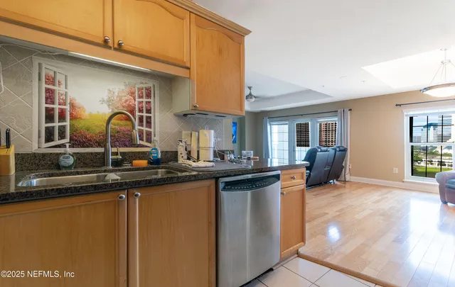 a kitchen with stainless steel appliances granite countertop a sink and cabinets