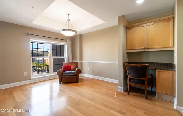 a living room with a bed furniture and a window