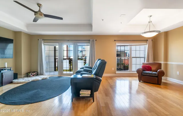 a living room with furniture and a wooden floor