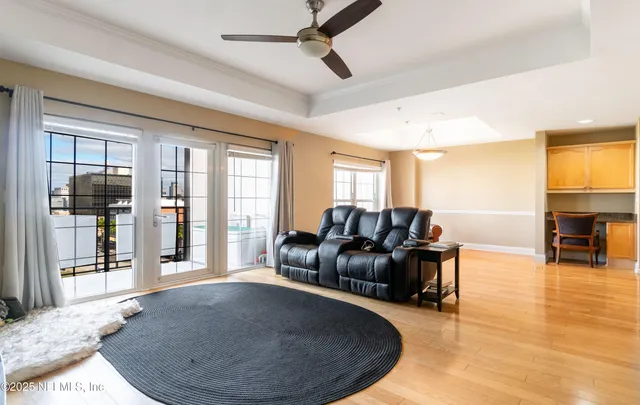 a living room with furniture and a kitchen area
