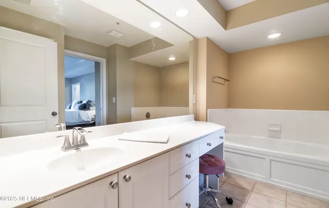 a view of washer and dryer with bathroom in the background