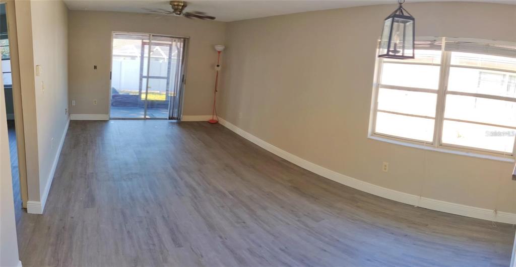 2472 Enterprise Road, Unit 6 Clearwater, FL 33763 - Photo 11 of 22 an empty room with wooden floor and windows