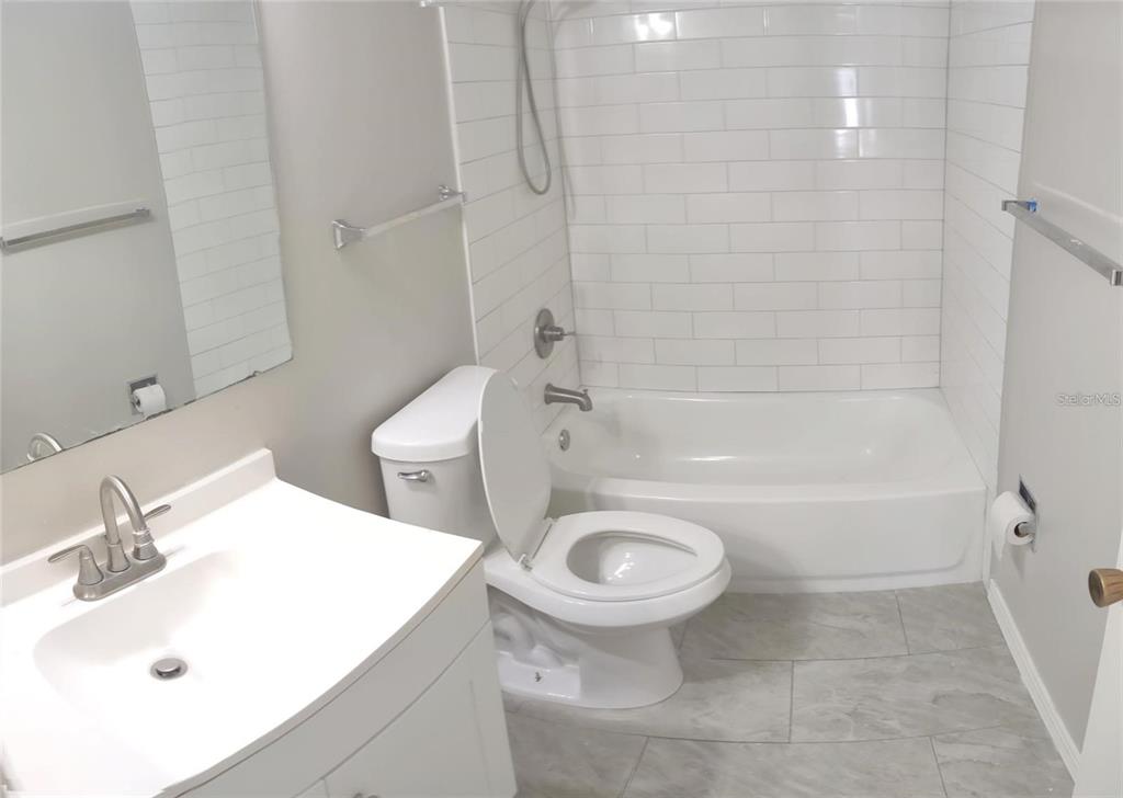 2472 Enterprise Road, Unit 6 Clearwater, FL 33763 - Photo 15 of 22 a bathroom with a sink a toilet and a bathtub