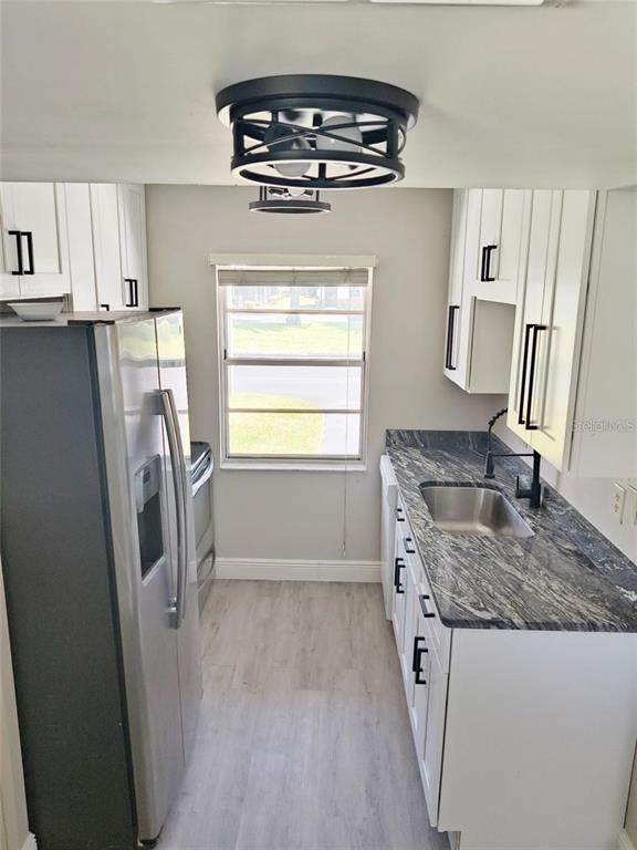 2472 Enterprise Road, Unit 6 Clearwater, FL 33763 - Photo 4 of 22 a kitchen with refrigerator a stove a sink and dishwasher