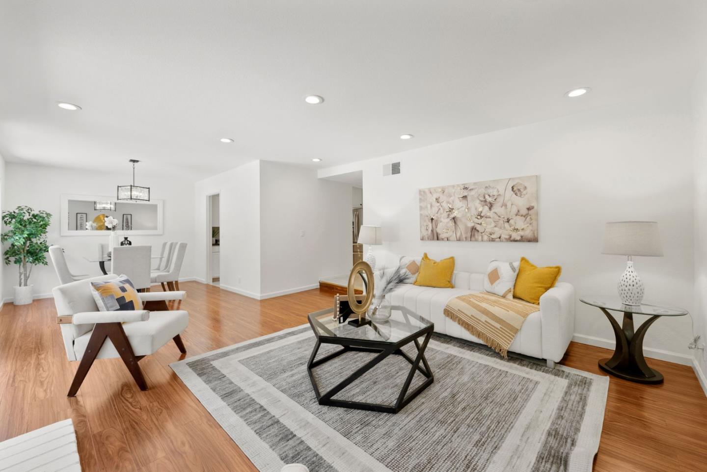 a living room with furniture and a wooden floor