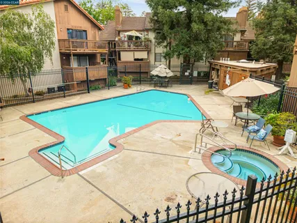 a view of a house with swimming pool and sitting area