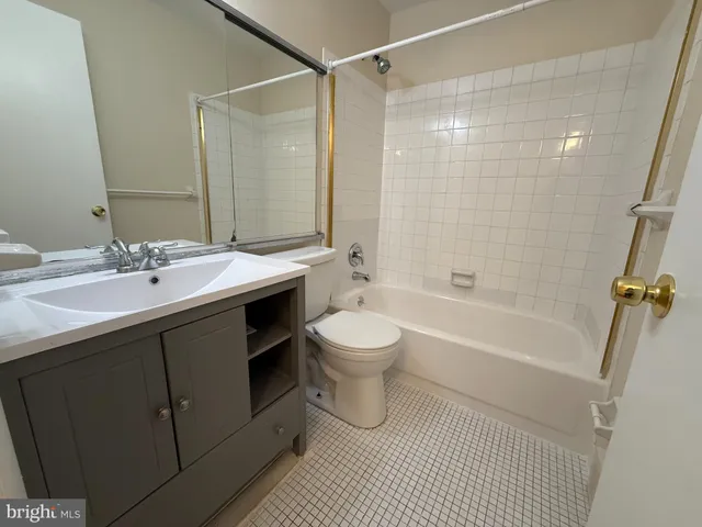 a bathroom with a double vanity sink toilet tub and shower