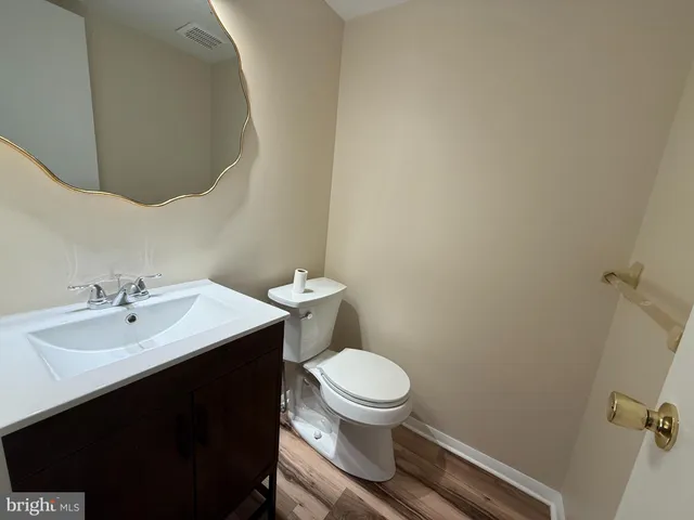 a bathroom with a sink a toilet and mirror