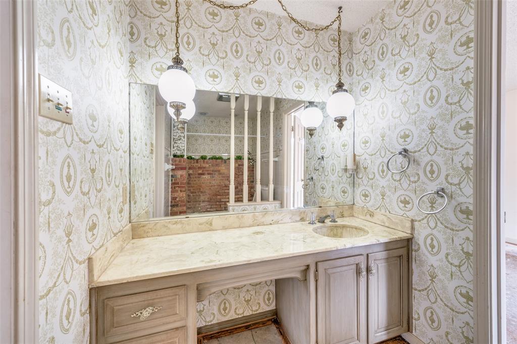 5001 Boulder Lake Road Fort Worth, TX 76103 - Photo 16 of 22 a bathroom with a sink and a mirror