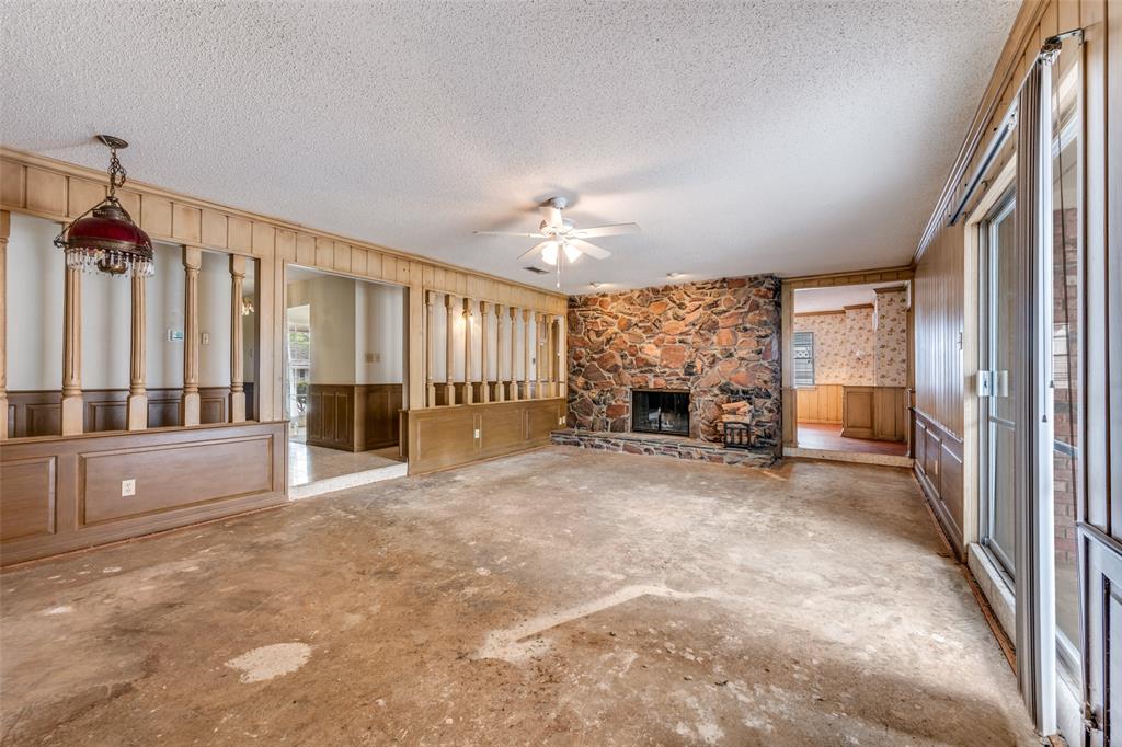 5001 Boulder Lake Road Fort Worth, TX 76103 - Photo 3 of 22 a view of an empty room with a fireplace and a window